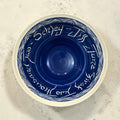 The Collected Chapter large cobalt blue handmade ceramic bowl with ivory sgraffito lettering and wave rim detail.