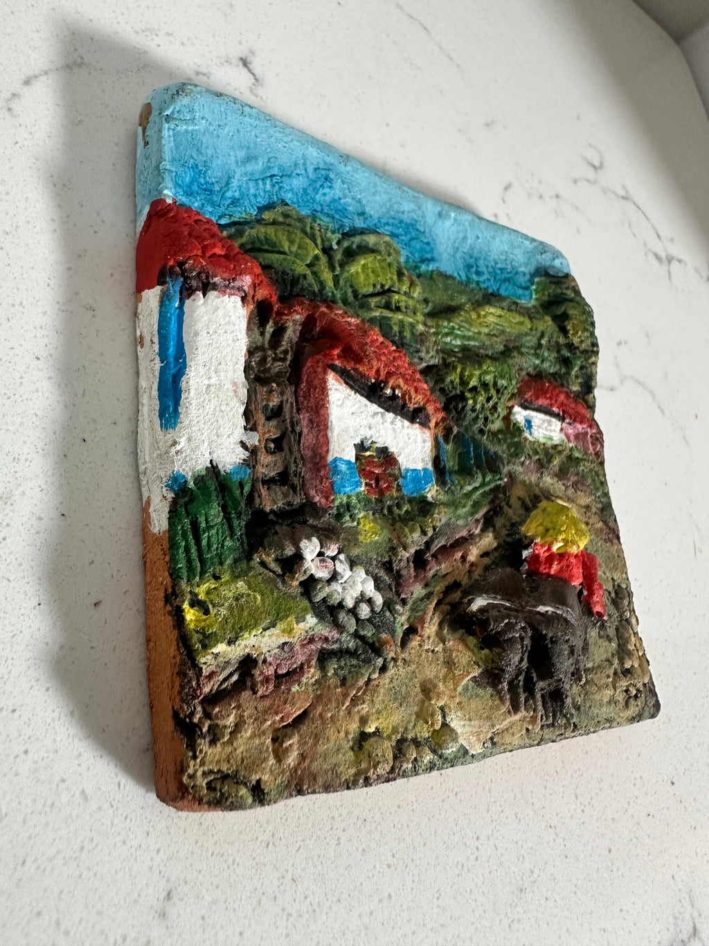 The Collected Chapter vintage Costa Rica ceramic relief wall plaque featuring a hand-painted 3D village scene.