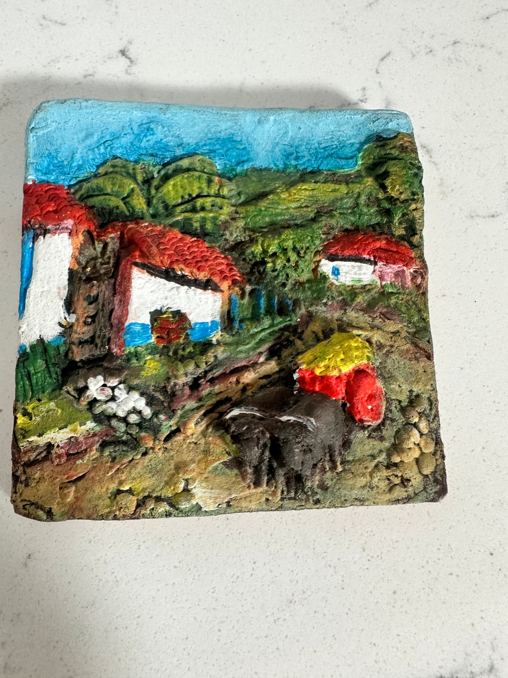 The Collected Chapter vintage Costa Rica ceramic relief wall plaque featuring a colorful hand-painted village scene.