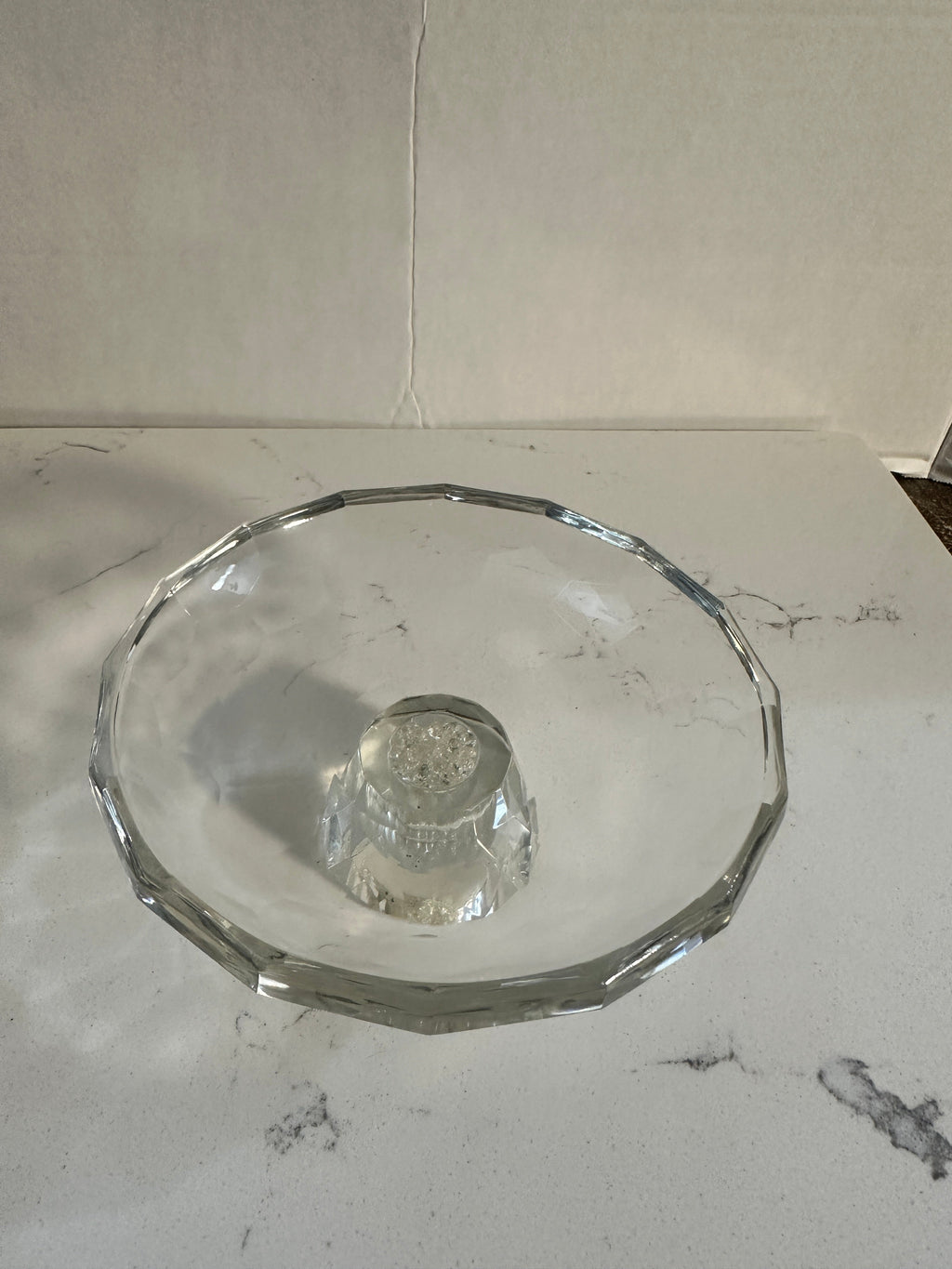 The Collected Chapter Oleg Cassini crystal pedestal bowl with a faceted geometric rim and crackle glass center.