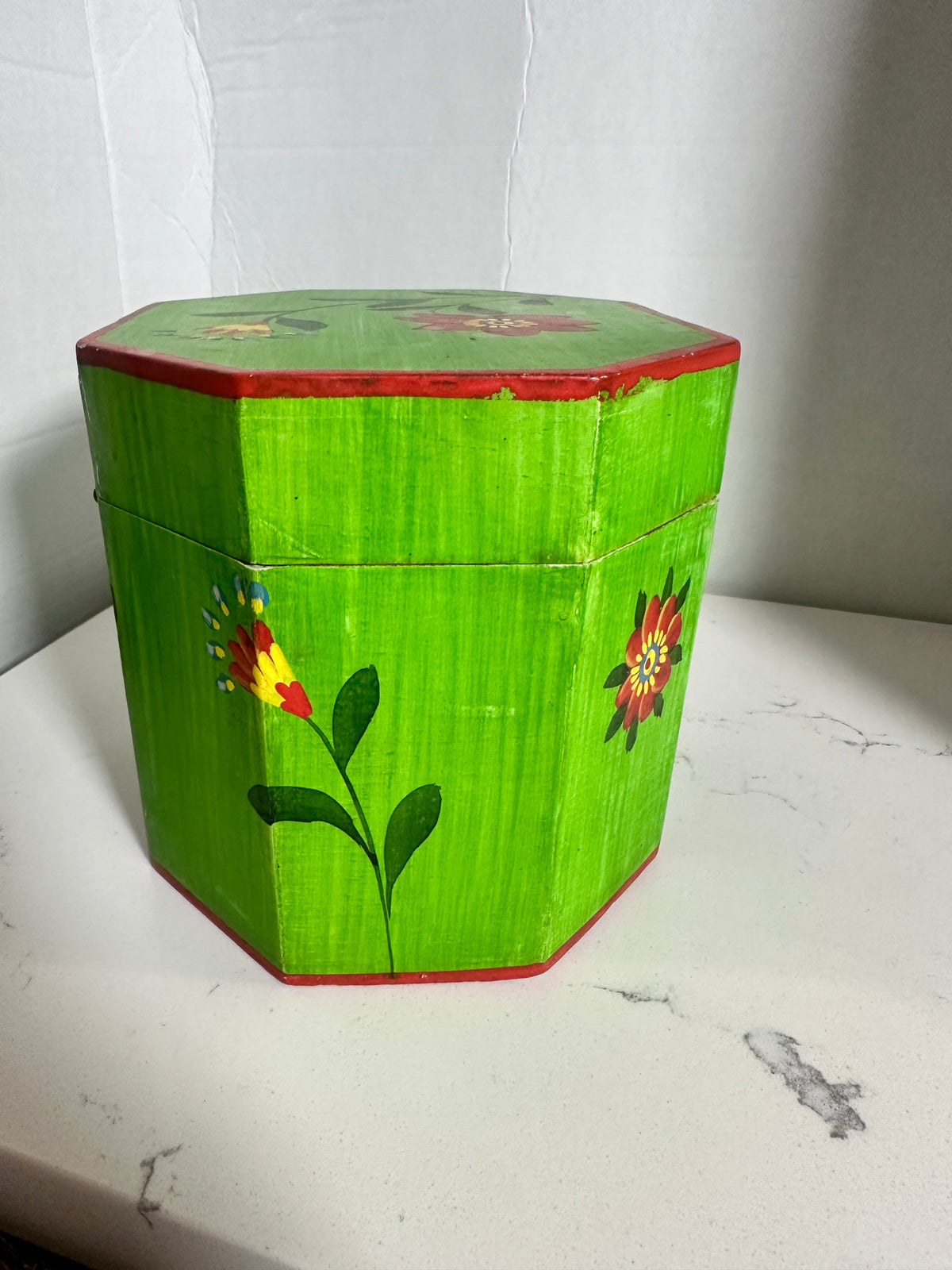 The Collected Chapter vintage octagonal wooden keepsake box with lime-green paint and hand-painted folk floral motifs.