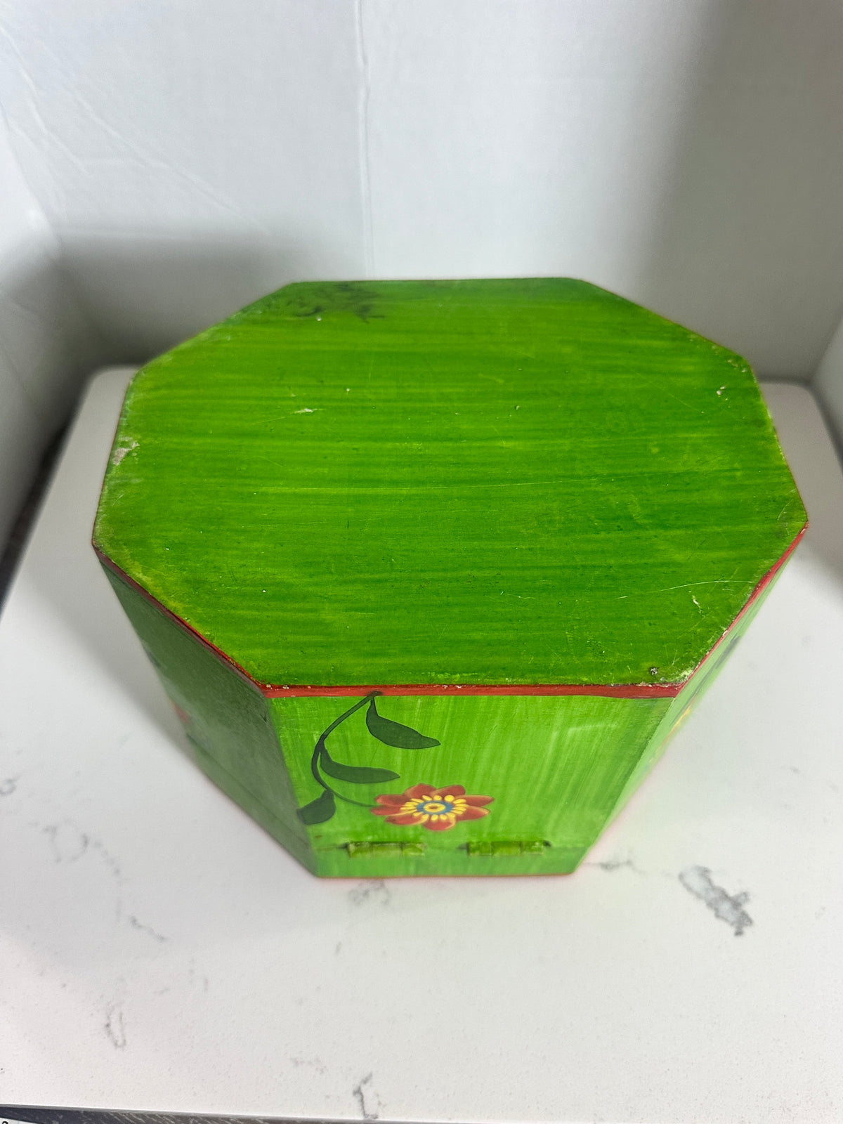 The Collected Chapter vintage octagonal wooden keepsake box in lime green with hand-painted floral folk art motifs.