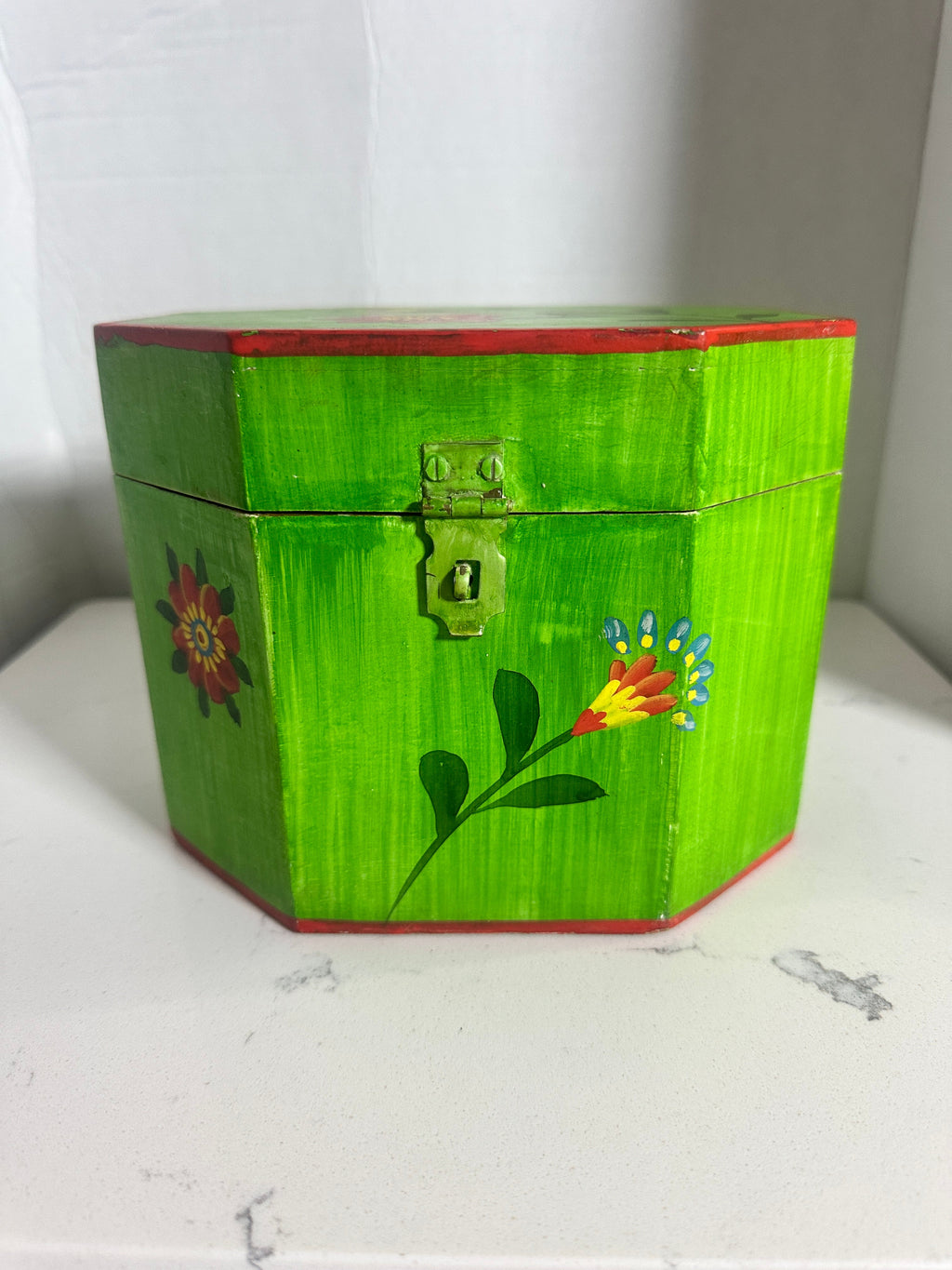 The Collected Chapter vintage octagonal wooden keepsake box in lime green with hand-painted folk art floral motifs.