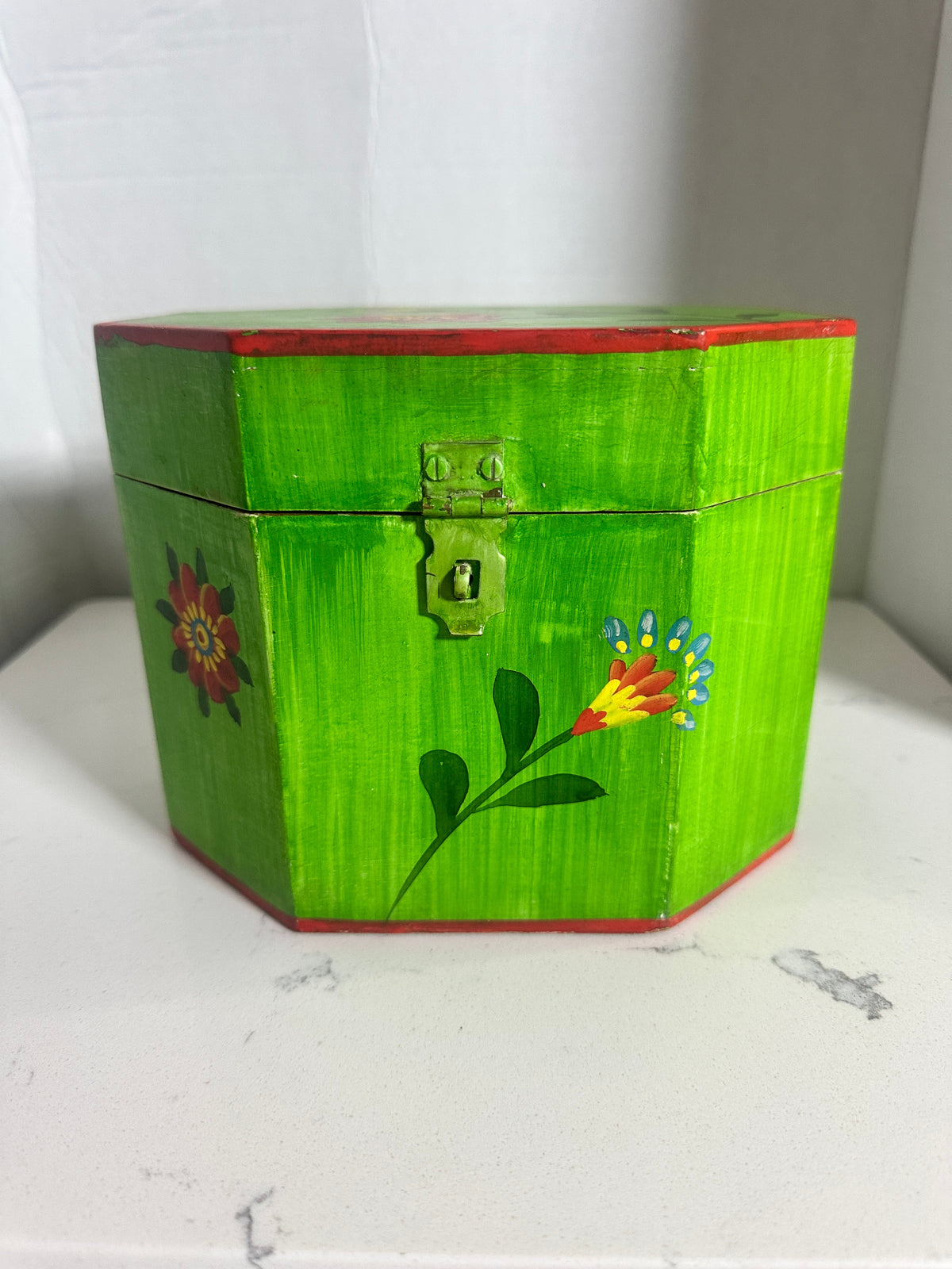 The Collected Chapter vintage octagonal wooden keepsake box in lime green with hand-painted folk art floral motifs.