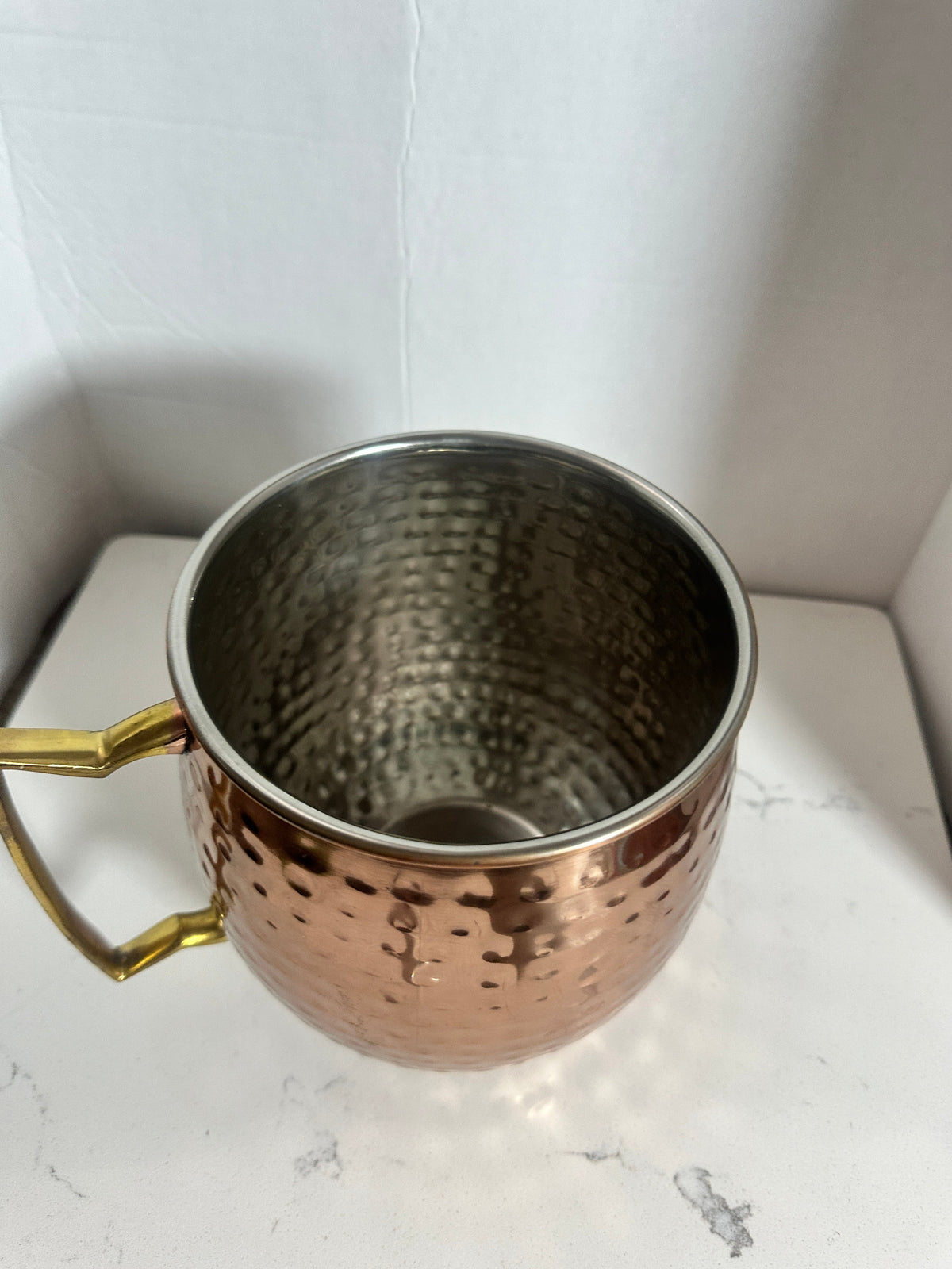 The Collected Chapter oversized hammered copper-tone tankard with a brass-tone handle and stainless-steel interior.