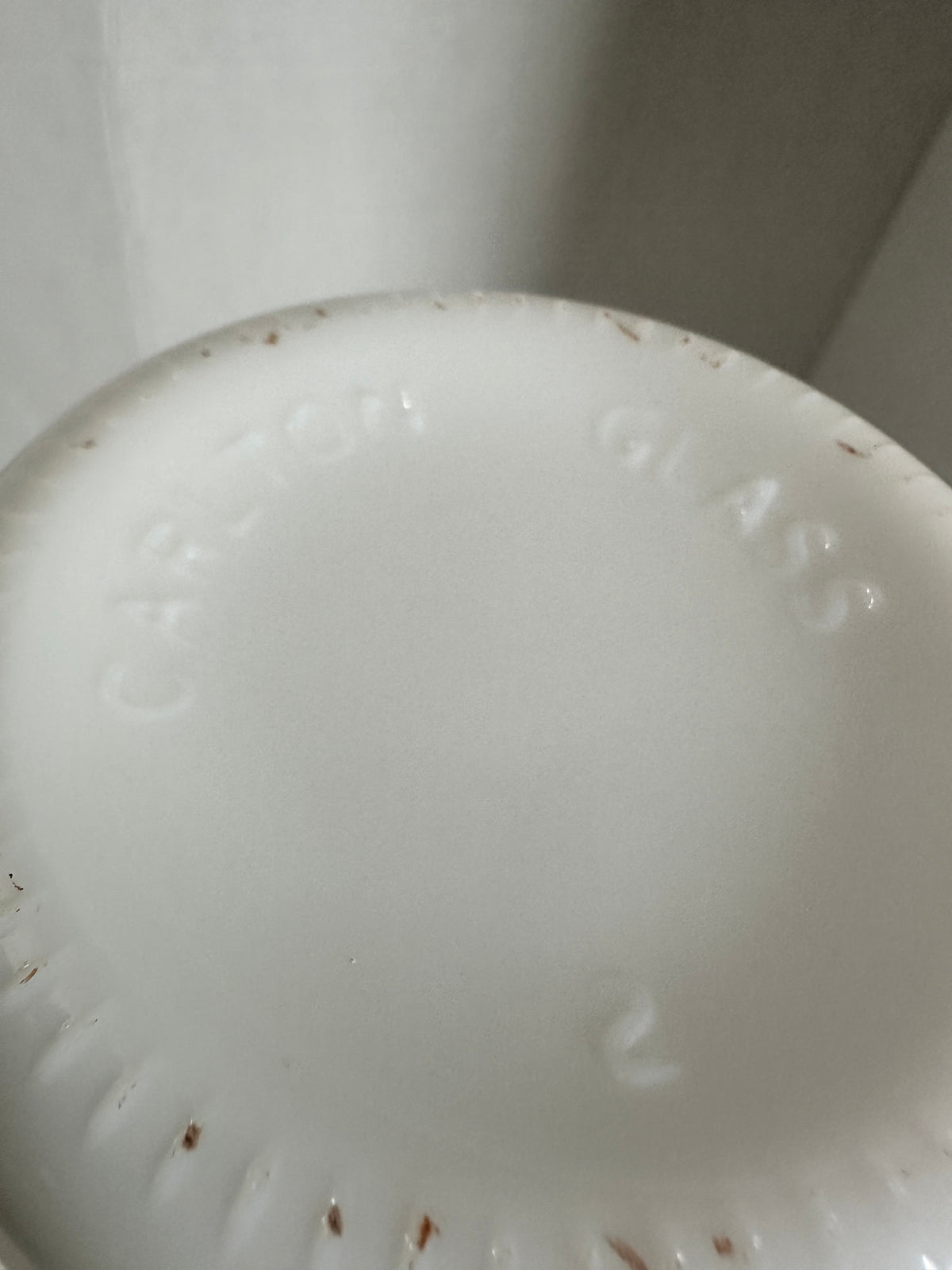 The Collected Chapter vintage milk glass vase base showing the embossed Carlton Glass maker mark on the white bottom