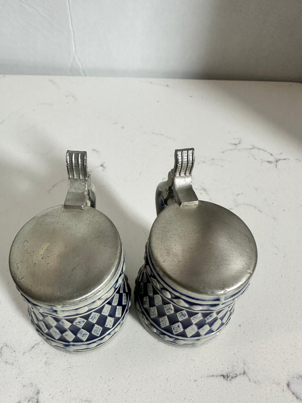 The Collected Chapter pair of vintage miniature beer steins with cobalt blue and cream diamond patterns and metal lids