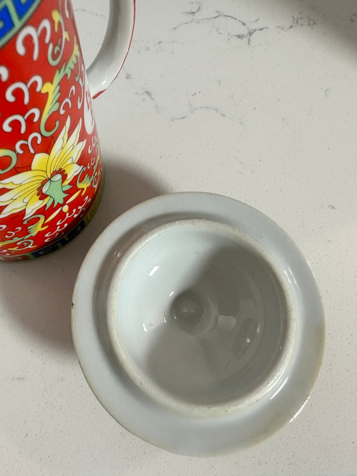 The Collected Chapter vintage Chinese Mun Shou porcelain tea mug lid and red floral patterned mug on white surface