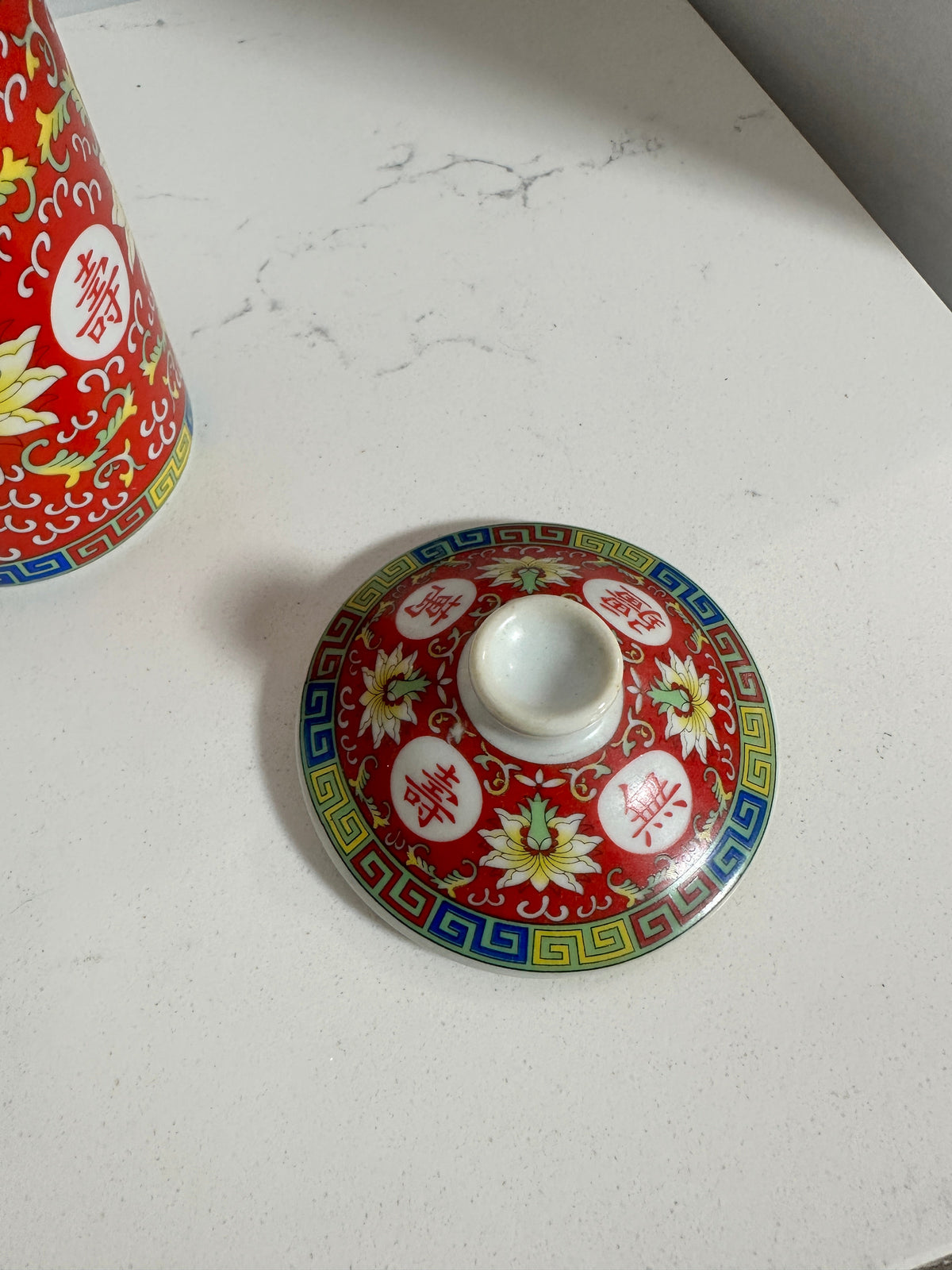 The Collected Chapter vintage Chinese Mun Shou porcelain tea mug lid with red floral pattern and Greek-key border