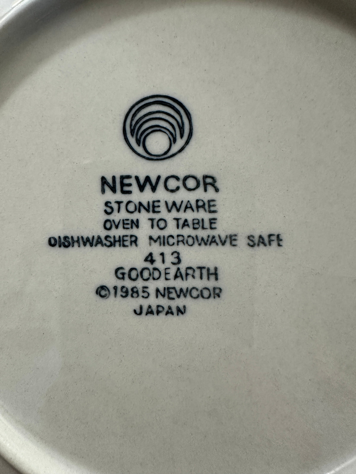 The Collected Chapter vintage 1985 Newcor Goodearth stoneware backstamp on the underside of a cream ceramic plate