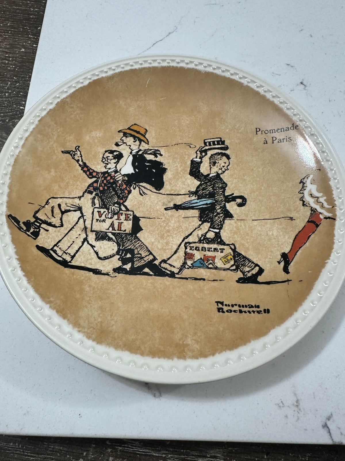 The Collected Chapter 1982 Norman Rockwell Promenade a Paris collector plate with a tan background and beaded rim.