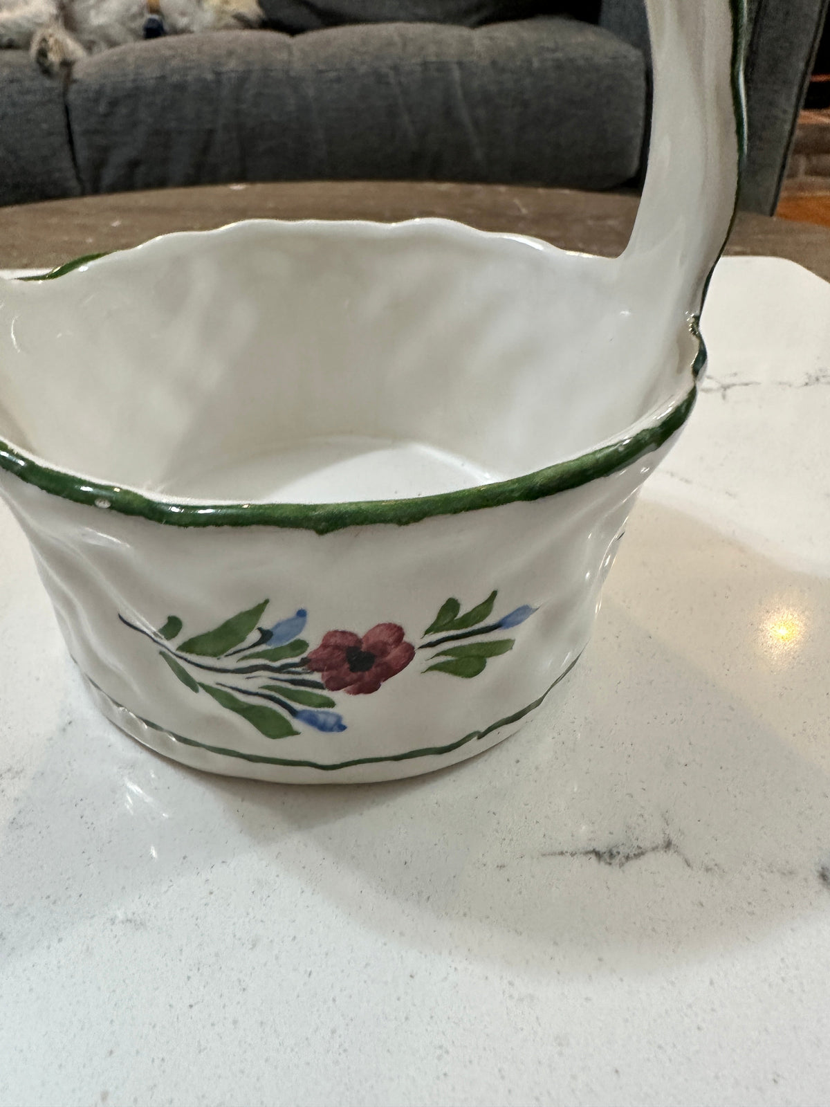 The Collected Chapter vintage Portuguese ceramic basket with hand-painted floral motifs and a scalloped green rim.