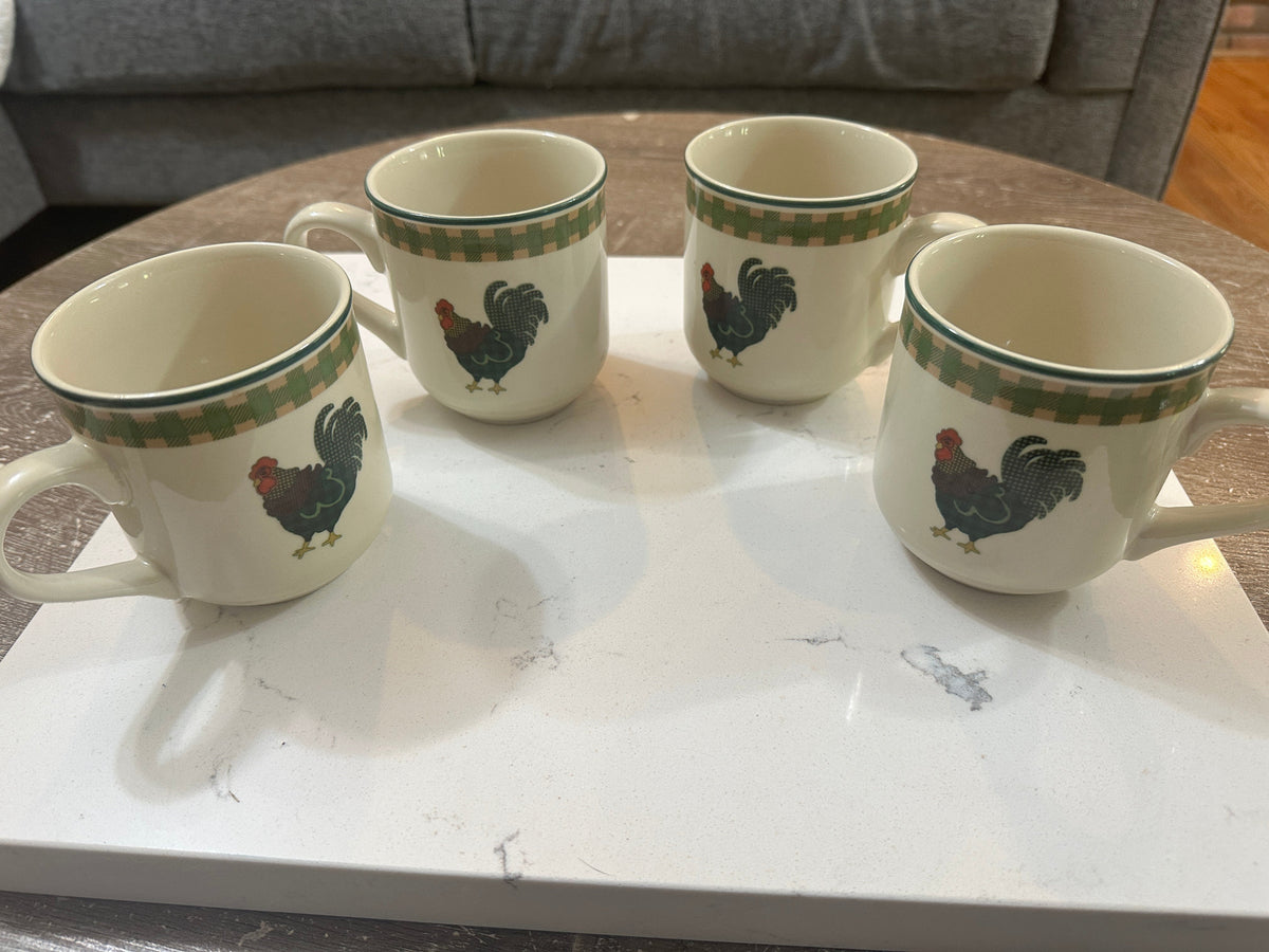 The Collected Chapter set of 4 vintage 1998 International China Rooster Morn stoneware mugs with green gingham trim.
