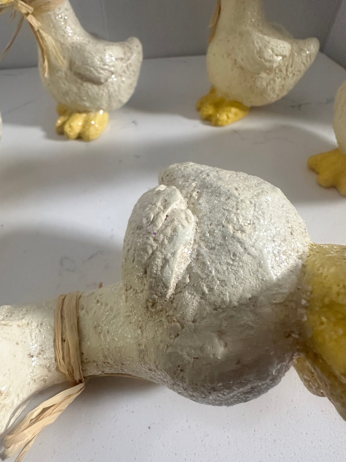 The Collected Chapter set of 5 rustic cream and yellow duck figurines with raffia neck ties and textured finish
