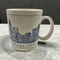 The Collected Chapter 2007 Starbucks Charlotte Queen City ceramic mug featuring a blue skyline illustration.