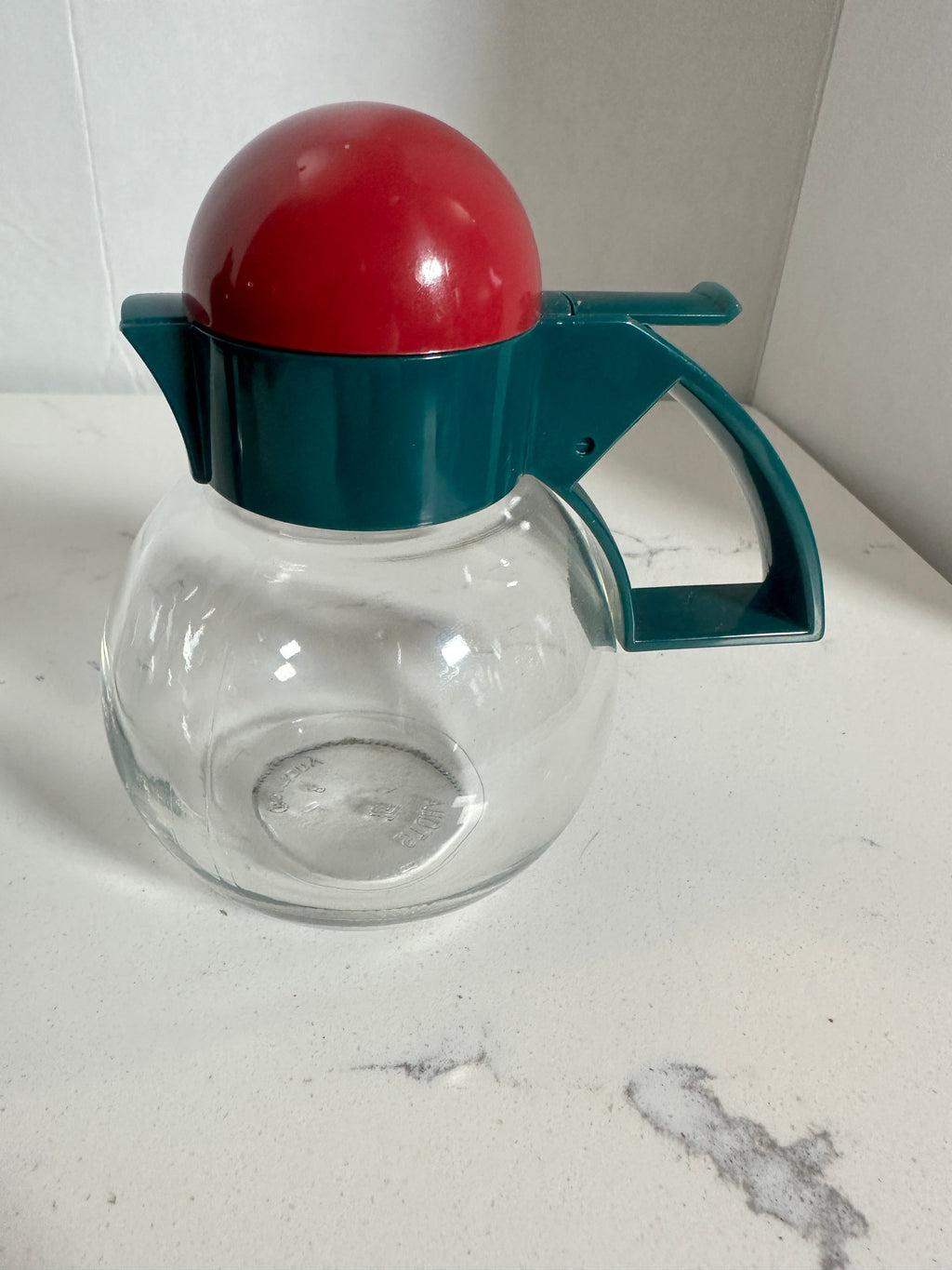 The Collected Chapter vintage STOHA Germany glass condiment server with a teal handle and red domed plastic lid.