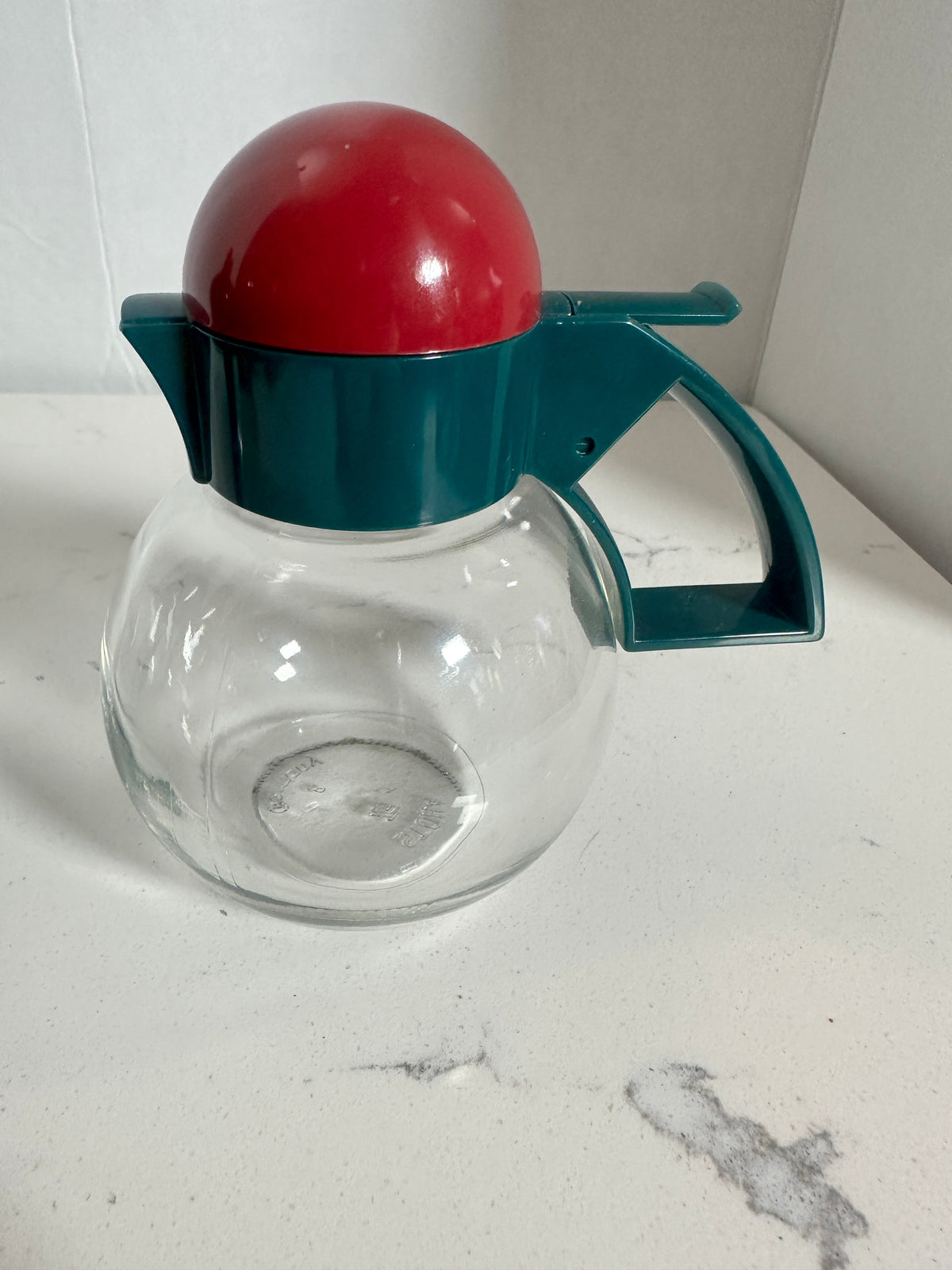 The Collected Chapter vintage STOHA Germany glass condiment server with a teal handle and red domed plastic lid.