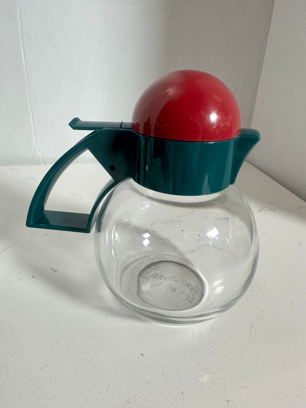 The Collected Chapter vintage STOHA Germany glass condiment server with a teal handle and a bright red domed lid.