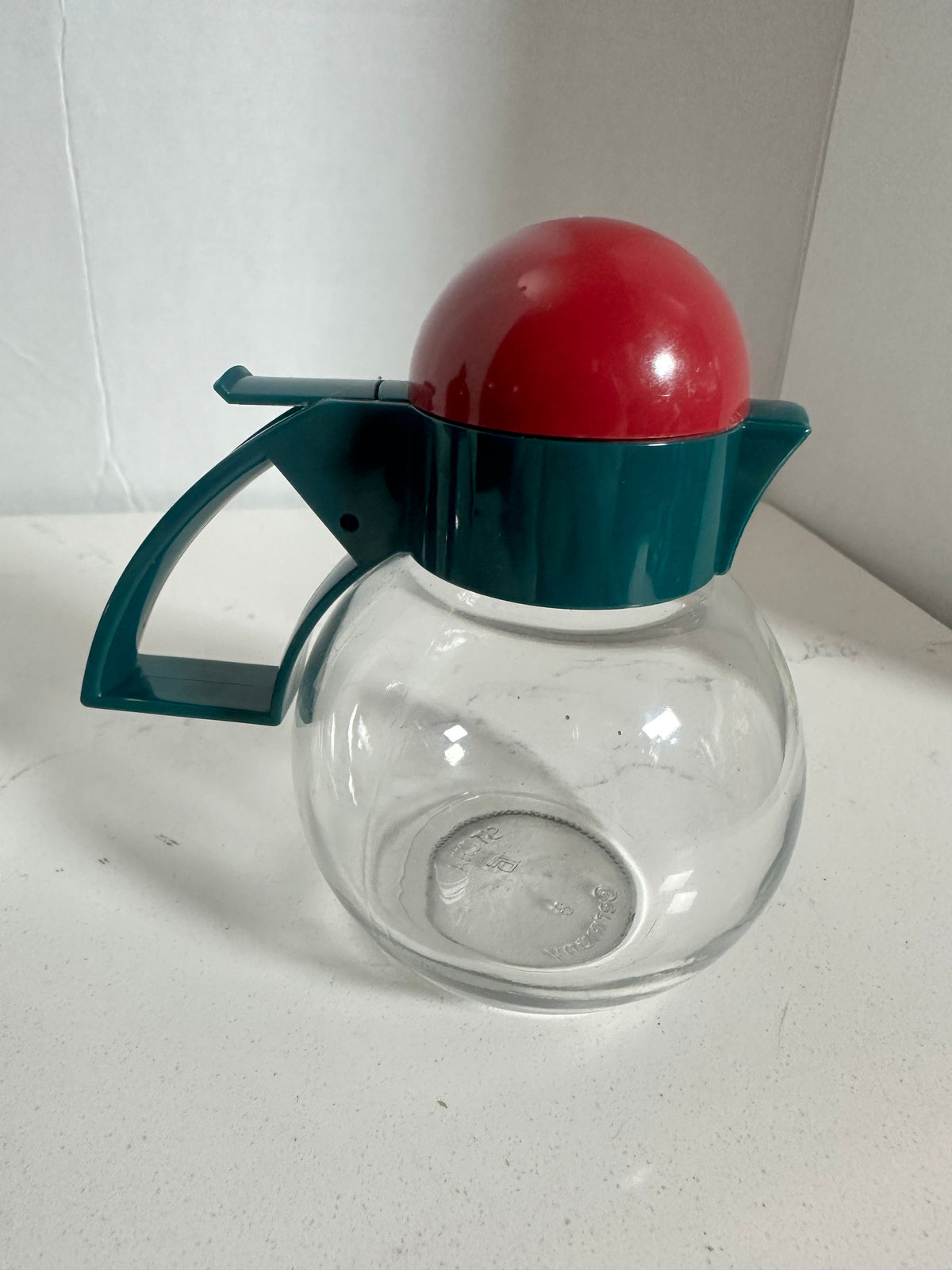 The Collected Chapter vintage STOHA Germany glass condiment server with a teal handle and a bright red domed lid.