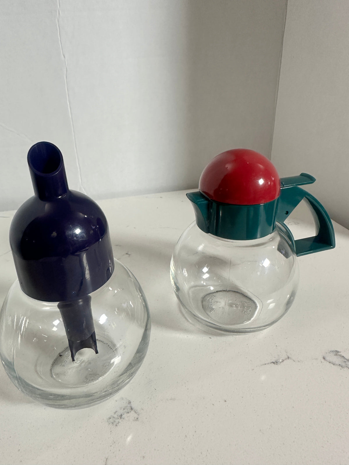 The Collected Chapter vintage STOHA Germany glass condiment set with a blue dispenser and a teal and red lidded jar.