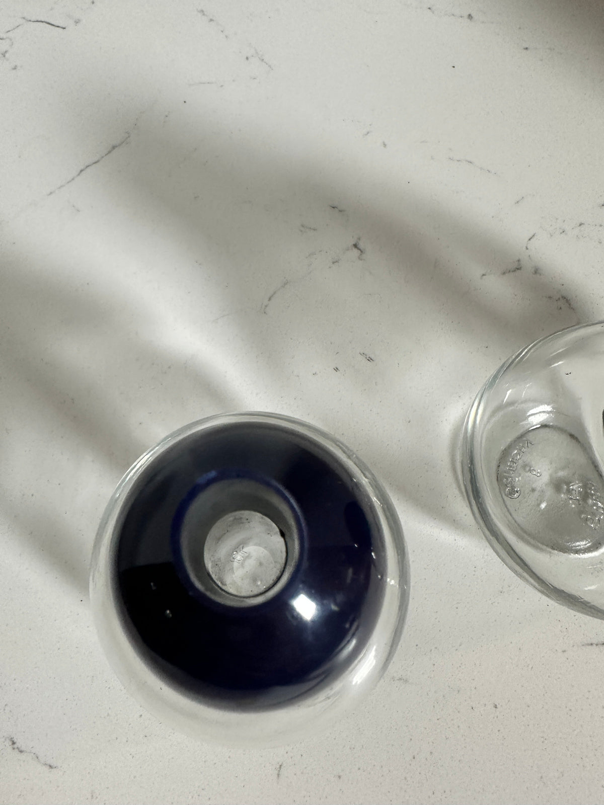 The Collected Chapter vintage STOHA Germany glass condiment set with a deep blue plastic dispenser top on white marble