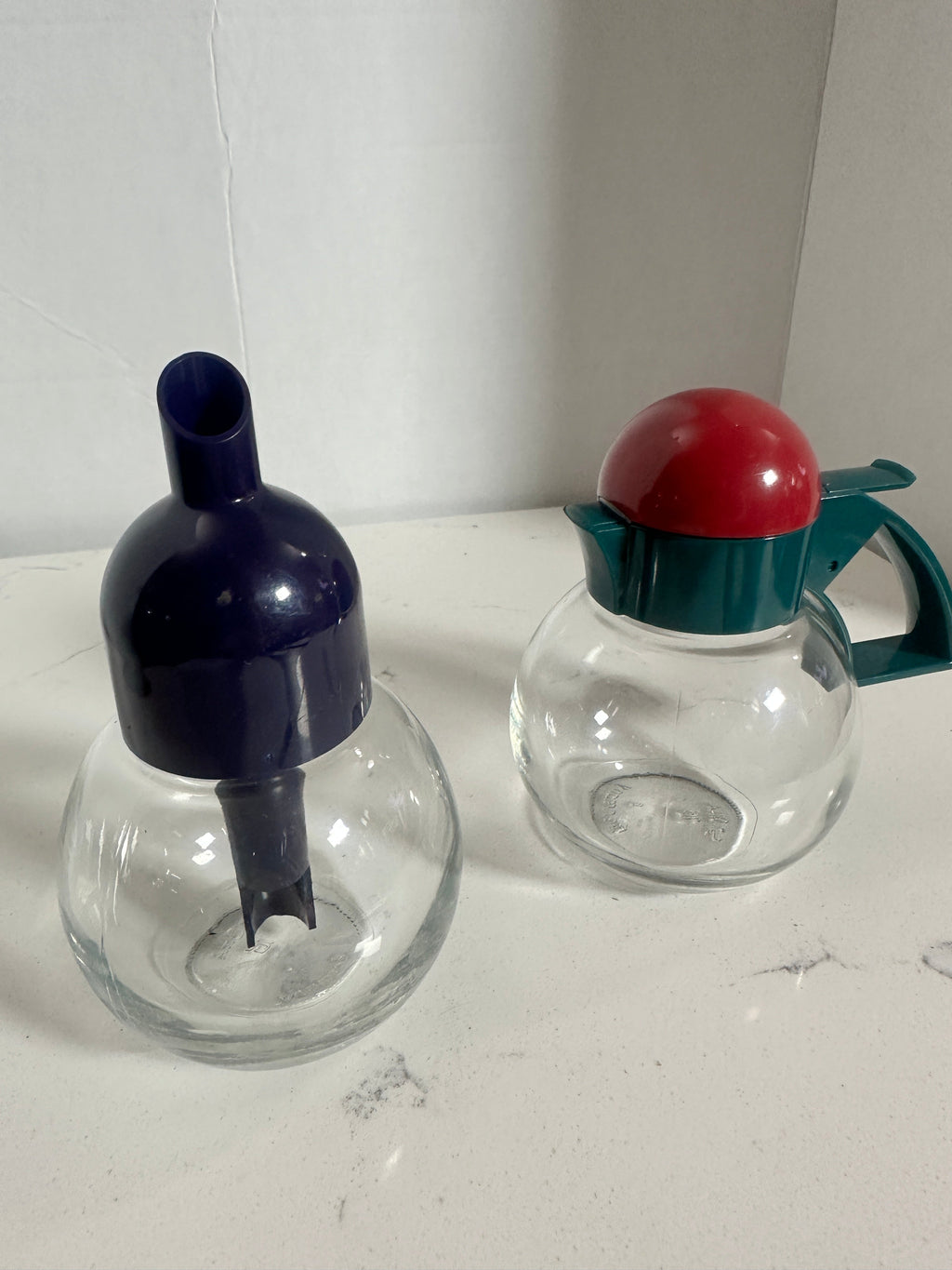 The Collected Chapter vintage STOHA Germany glass condiment set with colorful teal, red, and blue plastic lids.