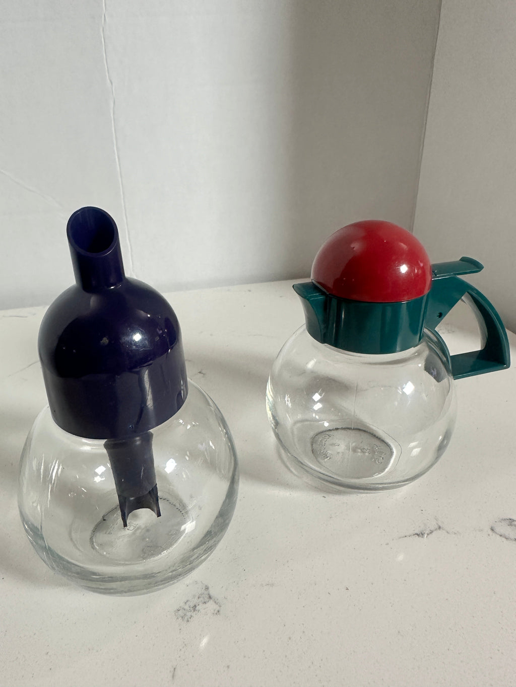 The Collected Chapter vintage STOHA Germany glass condiment set with colorful teal, red, and blue plastic lids.