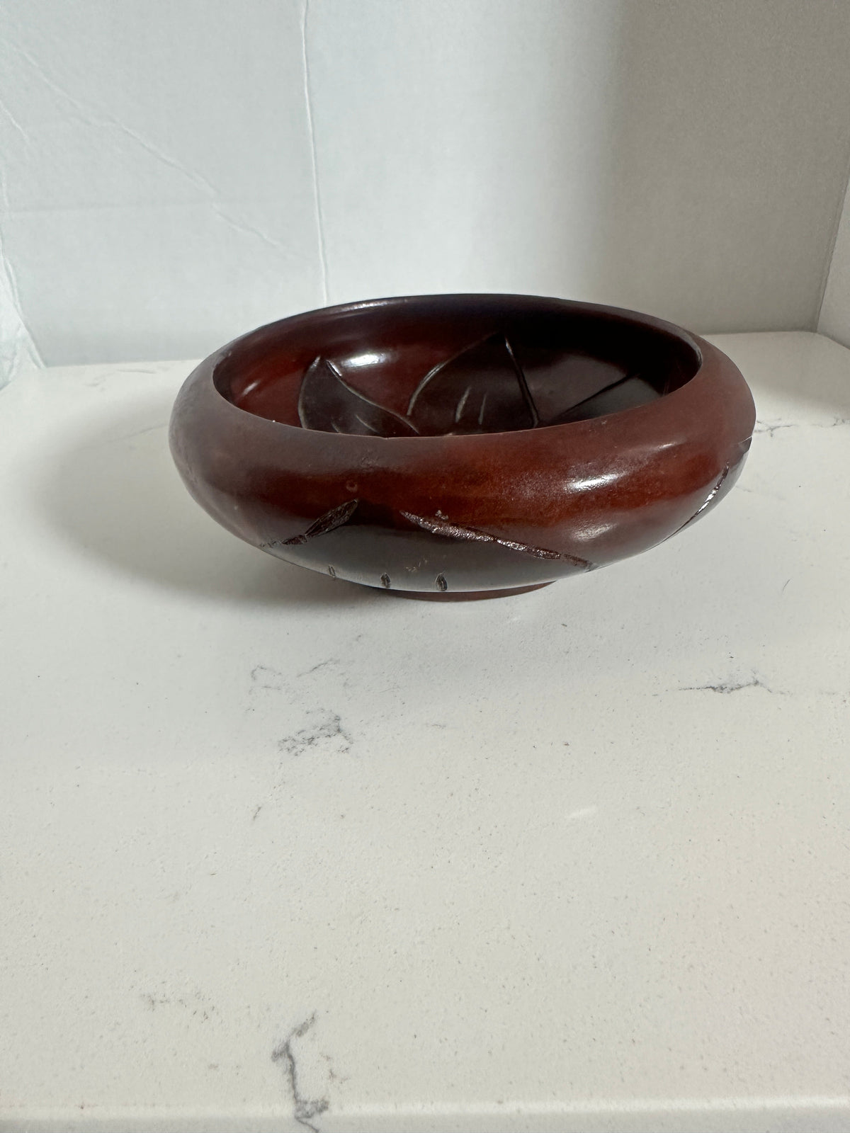 The Collected Chapter vintage 6-inch reddish-brown wood bowl with hand-carved floral and leaf patterns.