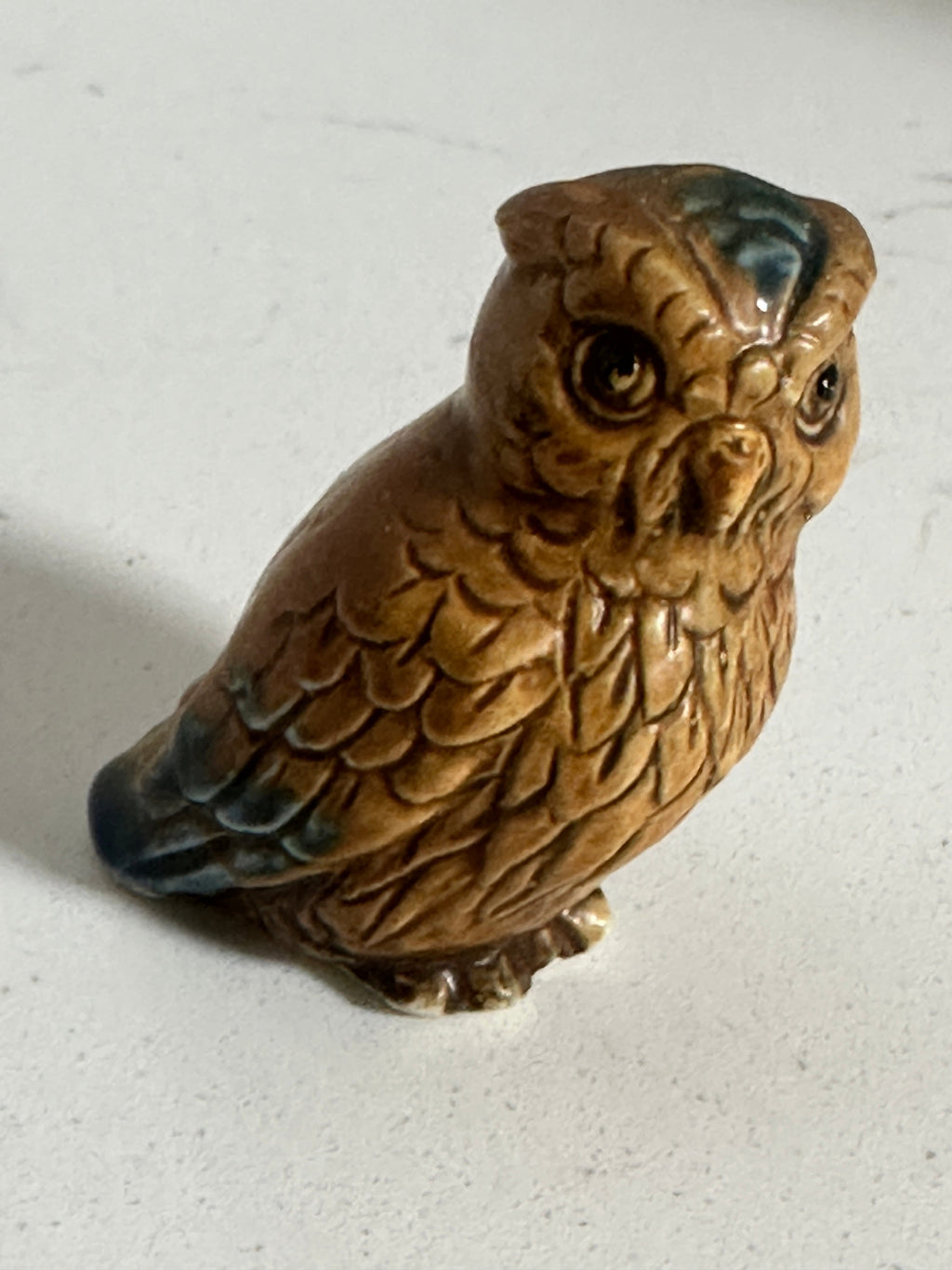 The Collected Chapter vintage 2-inch glazed ceramic owl figurine in brown with blue-green feather accents.