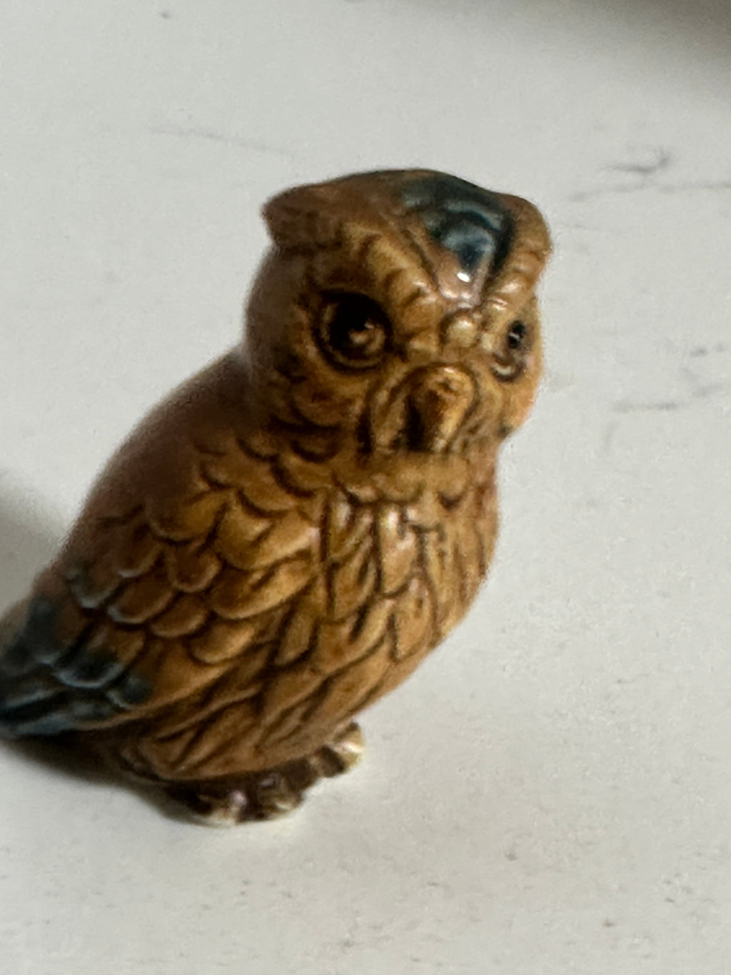The Collected Chapter vintage 2-inch glazed ceramic owl figurine in brown with blue-green feather accents.