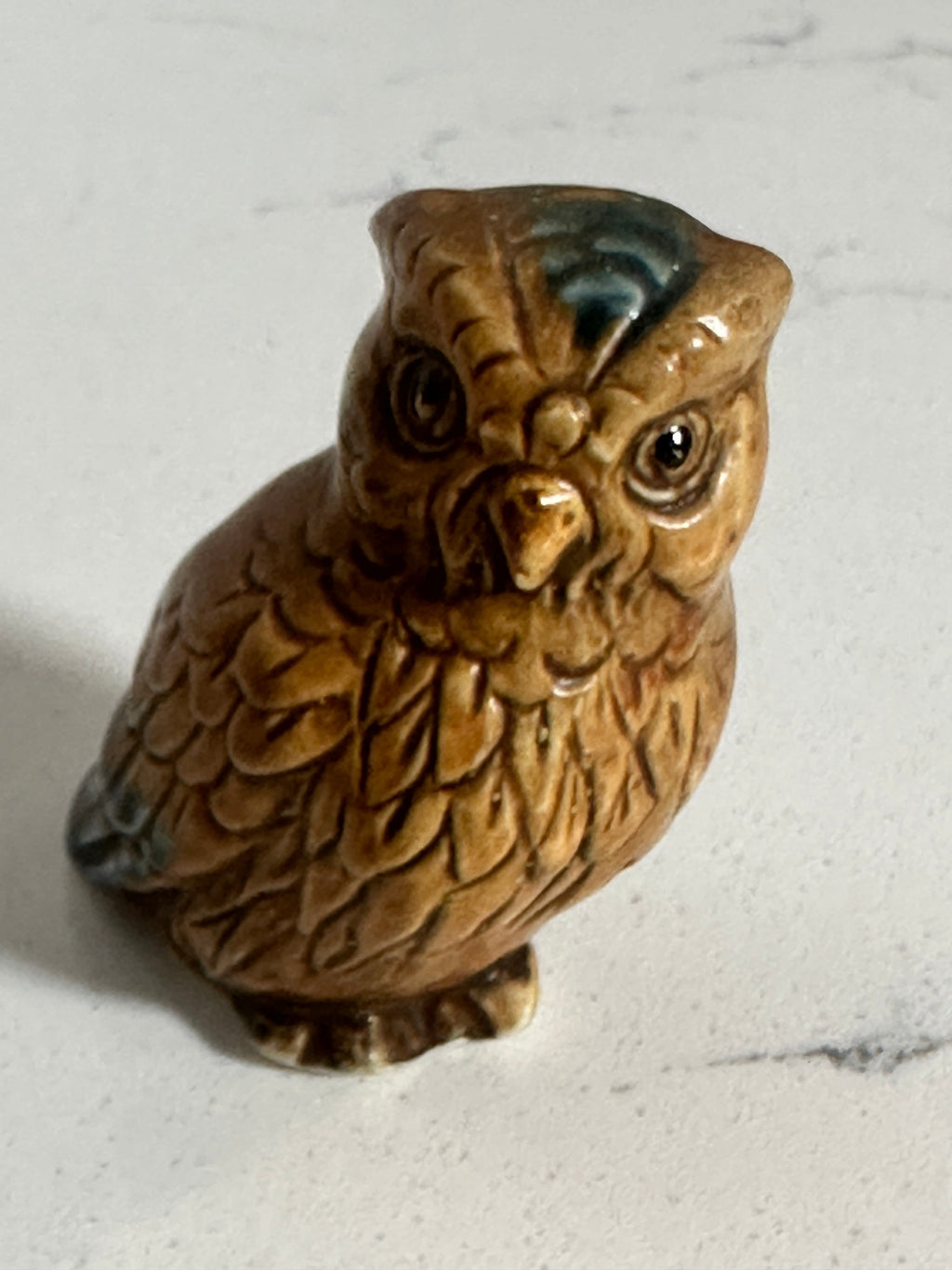 The Collected Chapter vintage 2-inch glazed ceramic owl figurine in brown with blue-green feather accents.