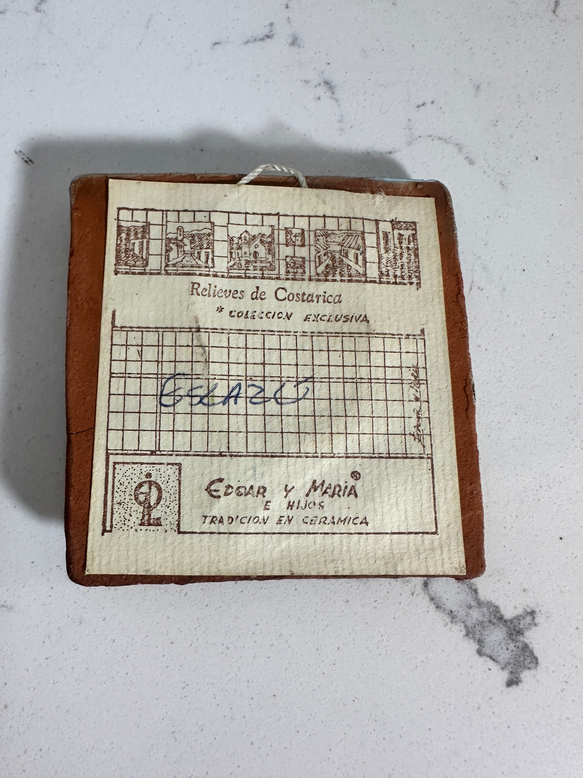 The Collected Chapter vintage Costa Rica ceramic plaque back view showing original maker label and hanging loop