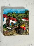 The Collected Chapter vintage Costa Rica ceramic relief wall plaque featuring a colorful hand-painted village scene.
