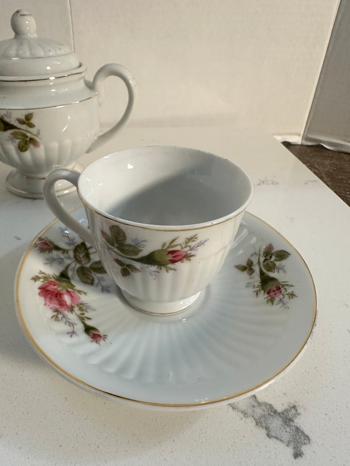 The Collected Chapter vintage Royal Sealy porcelain teacup and saucer with pink rose floral pattern and gold trim.