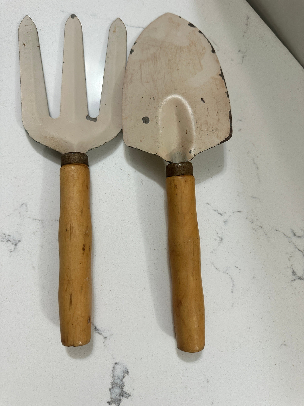 The Collected Chapter vintage hand-painted garden trowel and fork set with ivory metal and rustic wooden handles.