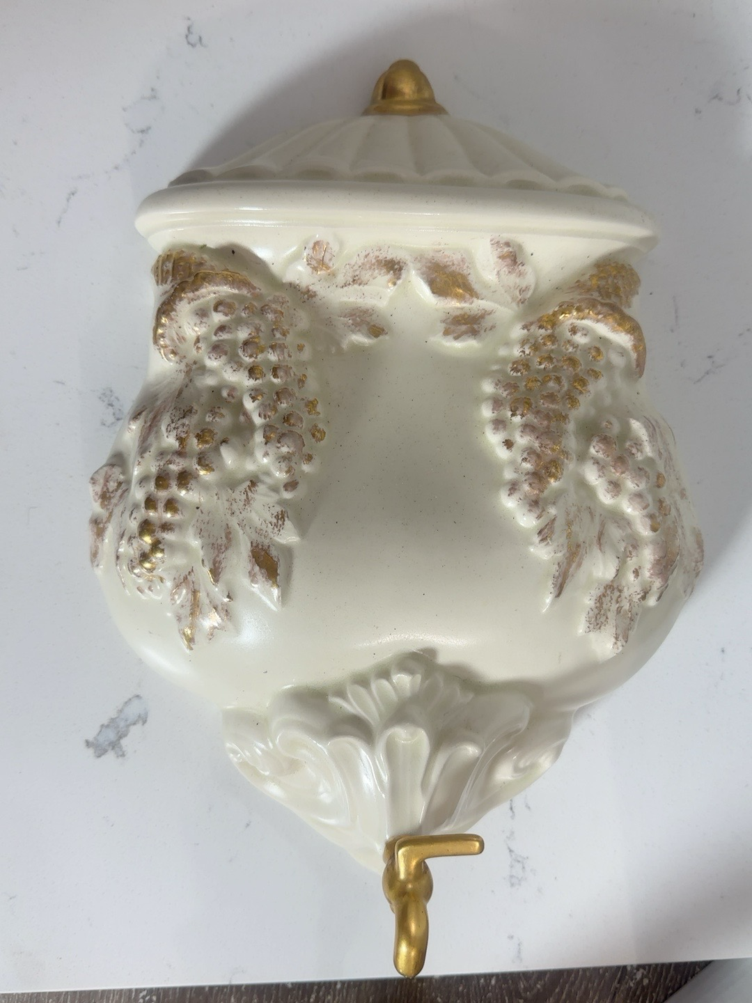 The Collected Chapter vintage cream resin wall dispenser with gold grape and vine relief and decorative spigot