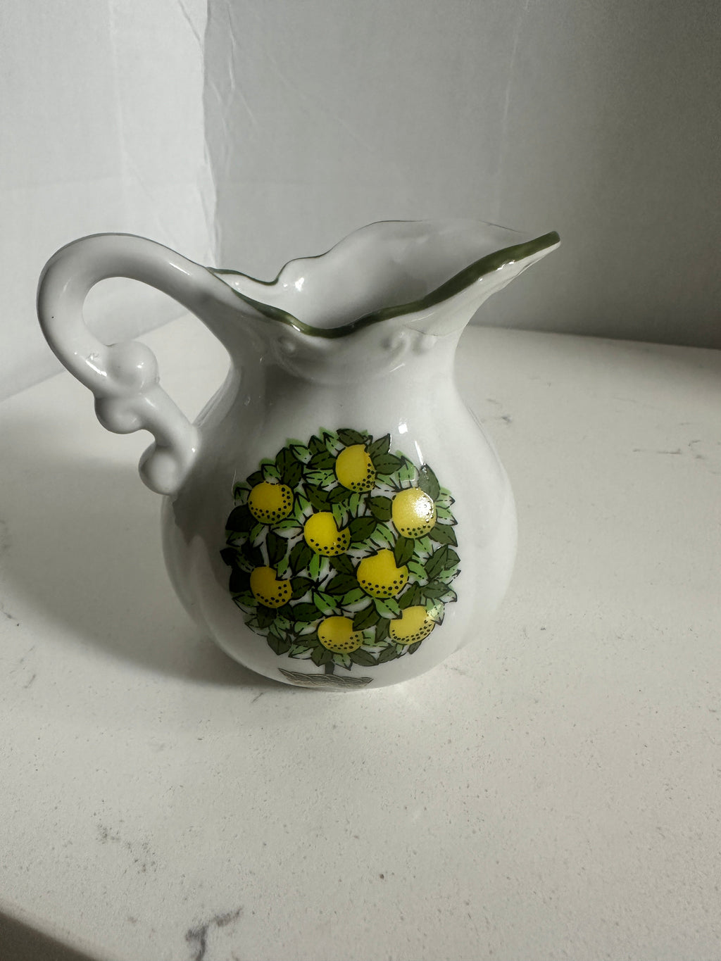 The Collected Chapter vintage porcelain miniature pitcher with a lemon tree motif and green scalloped rim.