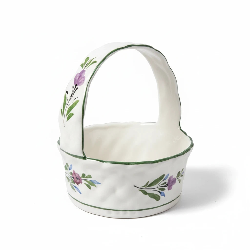 The Collected Chapter vintage Portuguese ceramic basket with hand-painted purple and green floral motifs and handle.