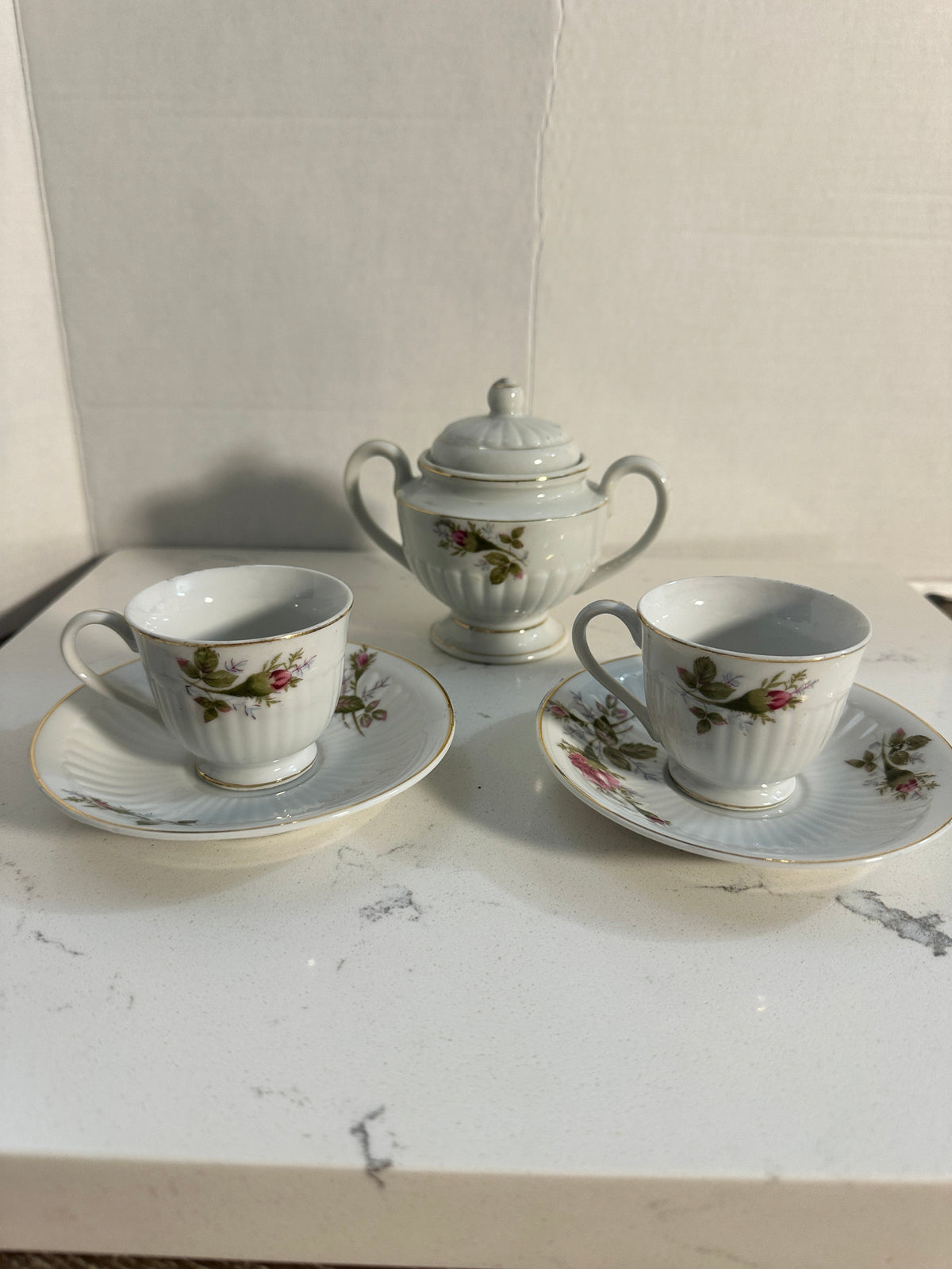 The Collected Chapter vintage Royal Sealy porcelain tea set with pink rose floral pattern, gold trim, and fluted edges.