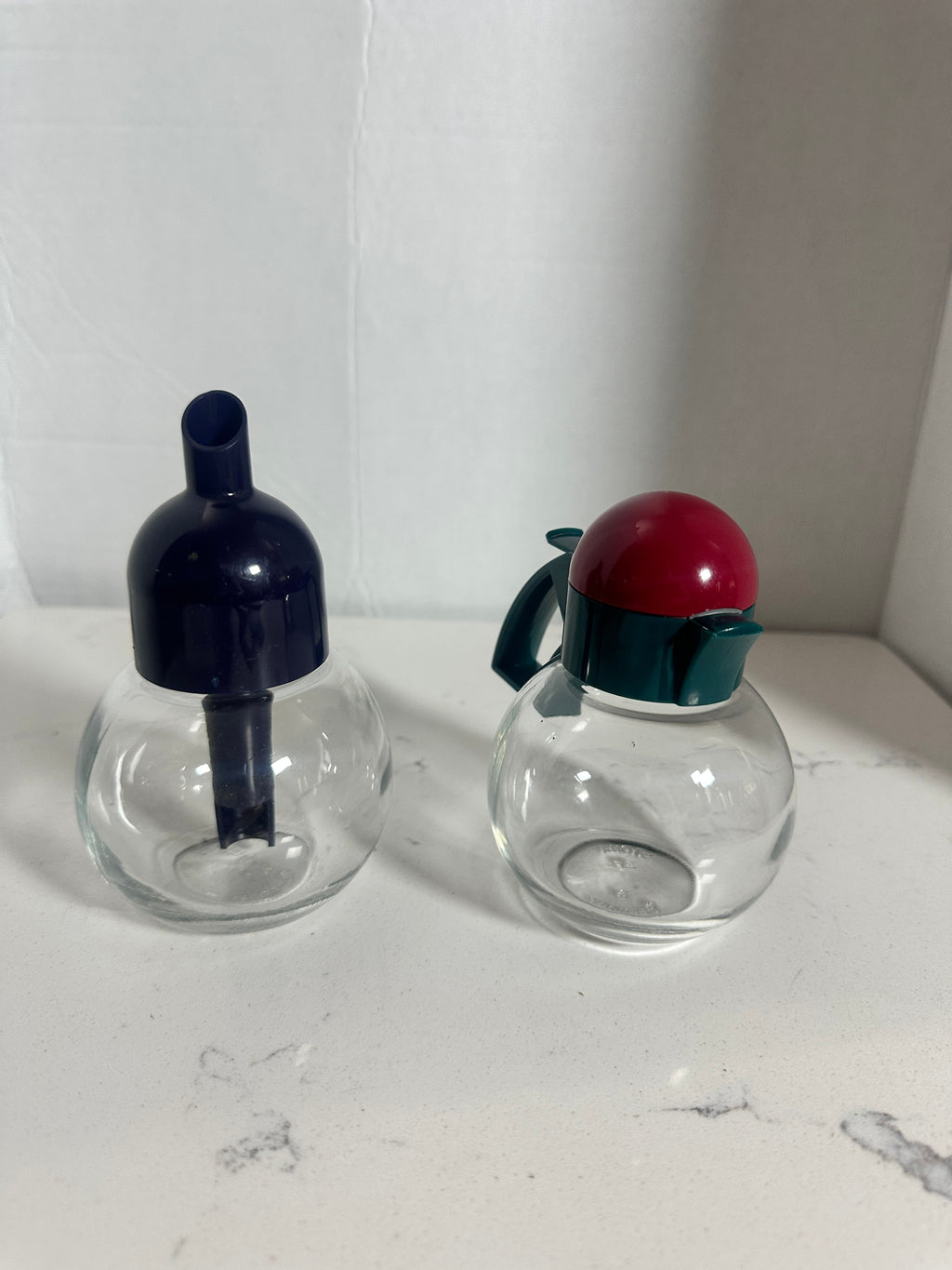 The Collected Chapter vintage STOHA Germany glass condiment set with colorful teal, red, and blue plastic lids.