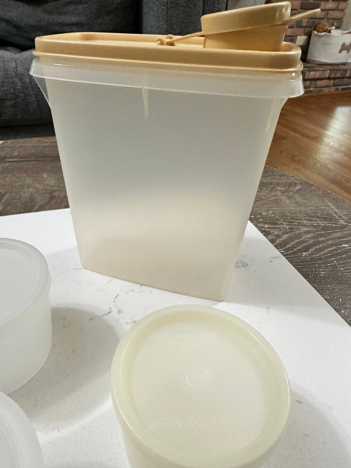 The Collected Chapter vintage Tupperware rectangular pantry container with almond flip-top lid and round canisters.